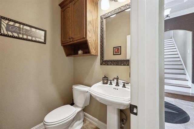 2014 Fish Lake Rd, Kountze, TX 77625 - half bath featuring baseboards, toilet, and a sink