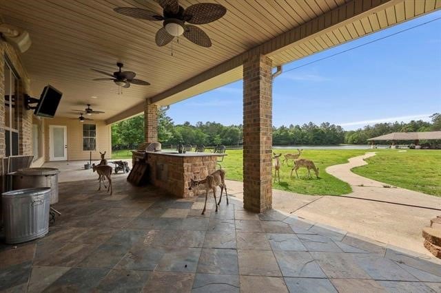 2014 Fish Lake Rd, Kountze, TX 77625 - view of patio / terrace featuring a ceiling fan and exterior kitchen