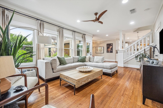 living area with a ceiling fan, light wood-style floors, stairs, baseboards, and recessed lighting