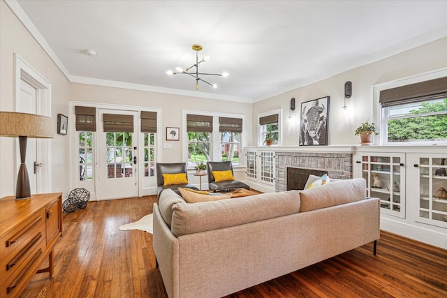 813 Key St, Houston, TX 77009 - living area with a chandelier, wood finished floors, crown molding, and a brick fireplace