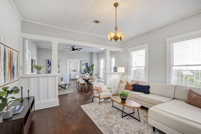 710 Woodland St, Houston, TX 77009 - living area with dark wood-style flooring, a chandelier, decorative columns, crown molding, and a ceiling fan