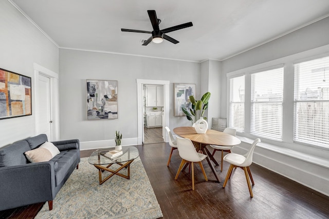 710 Woodland St, Houston, TX 77009 - living room featuring dark wood finished floors, baseboards, ornamental molding, and a ceiling fan