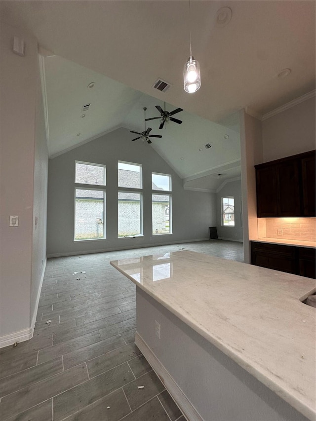 additional living space featuring baseboards, lofted ceiling, a ceiling fan, and wood finished floors