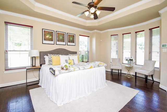 7003 Paxton Ct, Sugar Land, TX 77479 - bedroom featuring a tray ceiling, baseboards, dark wood-type flooring, and crown molding