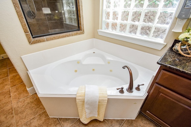 7003 Paxton Ct, Sugar Land, TX 77479 - full bathroom with a jetted tub, vanity, and tile patterned flooring