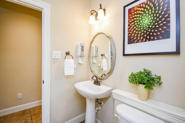 7003 Paxton Ct, Sugar Land, TX 77479 - half bath with toilet, tile patterned floors, and baseboards