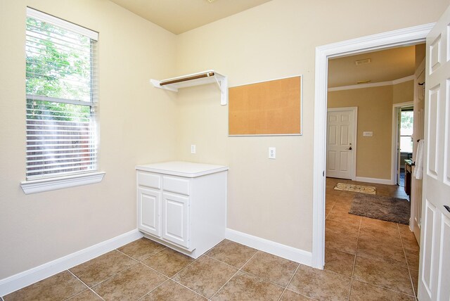 7003 Paxton Ct, Sugar Land, TX 77479 - clothes washing area with light tile patterned floors, plenty of natural light, baseboards, and ornamental molding