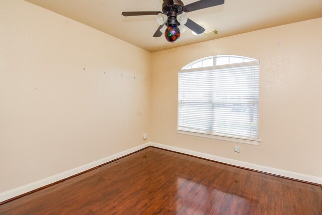 7003 Paxton Ct, Sugar Land, TX 77479 - unfurnished room with baseboards, wood finished floors, and a ceiling fan