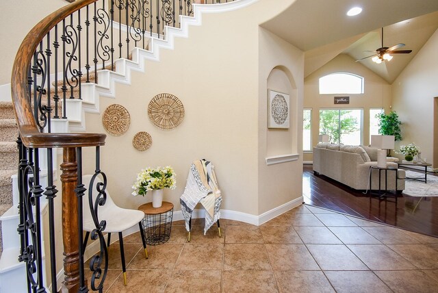 7003 Paxton Ct, Sugar Land, TX 77479 - entryway featuring a ceiling fan, stairs, tile patterned floors, baseboards, and high vaulted ceiling