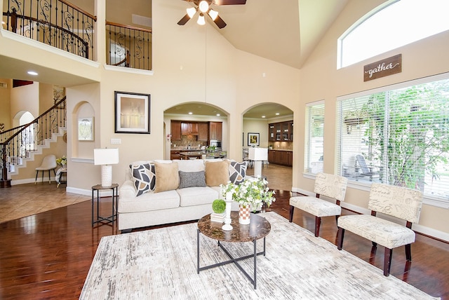 7003 Paxton Ct, Sugar Land, TX 77479 - living area with ceiling fan, arched walkways, stairs, wood finished floors, and baseboards