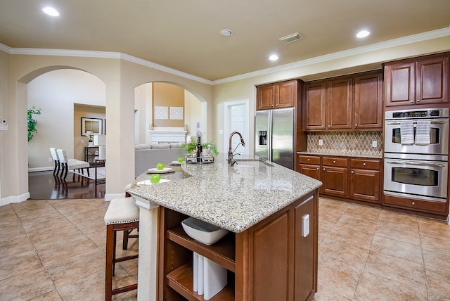 7003 Paxton Ct, Sugar Land, TX 77479 - kitchen with appliances with stainless steel finishes, a sink, arched walkways, crown molding, and open shelves