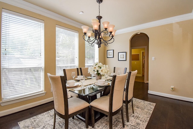 7003 Paxton Ct, Sugar Land, TX 77479 - dining area with arched walkways, baseboards, dark wood-style floors, a chandelier, and crown molding