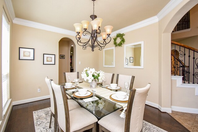 7003 Paxton Ct, Sugar Land, TX 77479 - dining space featuring arched walkways, a chandelier, baseboards, stairs, and crown molding