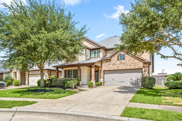 27106 Cottage Stream Ln, Fulshear, TX 77441 - view of front of home featuring concrete driveway, a front yard, and stone siding