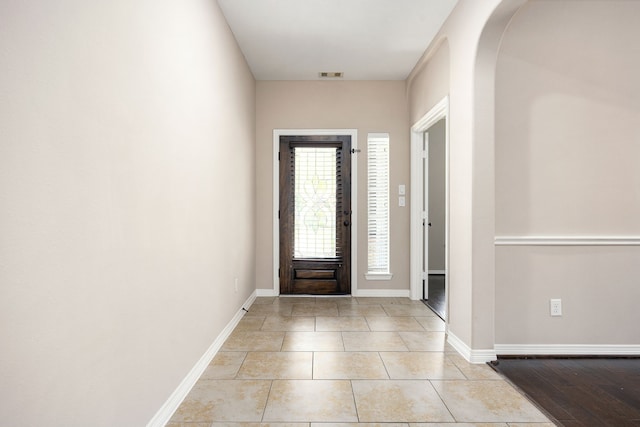 27106 Cottage Stream Ln, Fulshear, TX 77441 - entrance foyer with arched walkways, light tile patterned floors, and baseboards