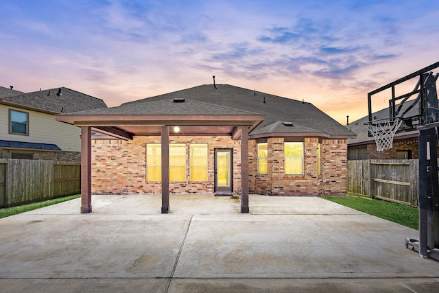 27106 Cottage Stream Ln, Fulshear, TX 77441 - back of house featuring brick siding, fence, a patio, and roof with shingles