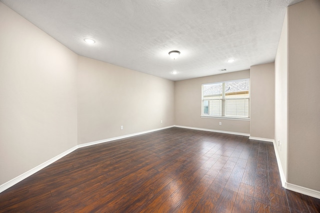 27106 Cottage Stream Ln, Fulshear, TX 77441 - unfurnished room with baseboards, dark wood-type flooring, recessed lighting, and a textured ceiling