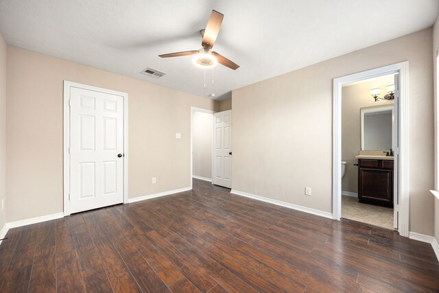 27106 Cottage Stream Ln, Fulshear, TX 77441 - unfurnished bedroom with dark wood finished floors, baseboards, and ensuite bathroom