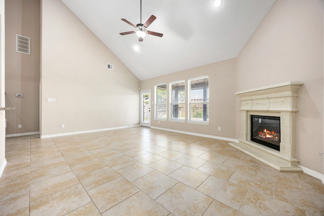 27106 Cottage Stream Ln, Fulshear, TX 77441 - unfurnished living room featuring high vaulted ceiling, ceiling fan, a premium fireplace, baseboards, and light tile patterned floors