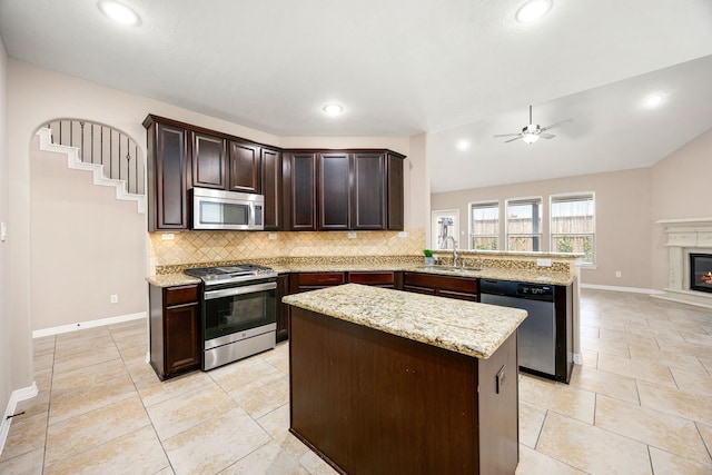 27106 Cottage Stream Ln, Fulshear, TX 77441 - kitchen featuring stainless steel appliances, a peninsula, tasteful backsplash, ceiling fan, and a sink