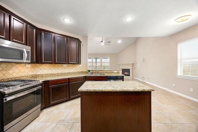 27106 Cottage Stream Ln, Fulshear, TX 77441 - kitchen with appliances with stainless steel finishes, a sink, tasteful backsplash, a ceiling fan, and vaulted ceiling
