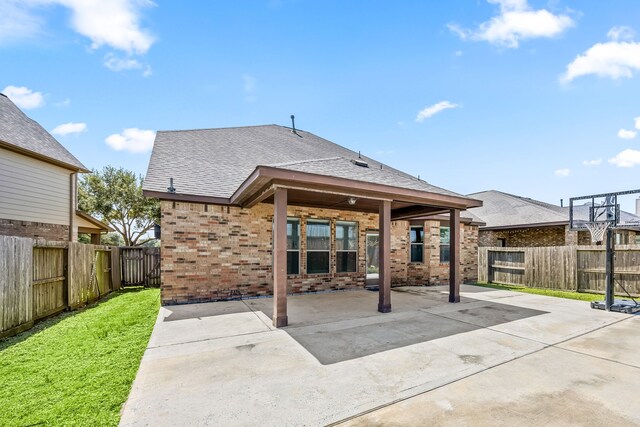 27106 Cottage Stream Ln, Fulshear, TX 77441 - back of house with brick siding, a patio, and roof with shingles
