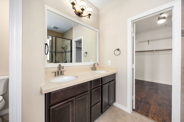 27106 Cottage Stream Ln, Fulshear, TX 77441 - bathroom with a shower stall, toilet, a walk in closet, and double vanity
