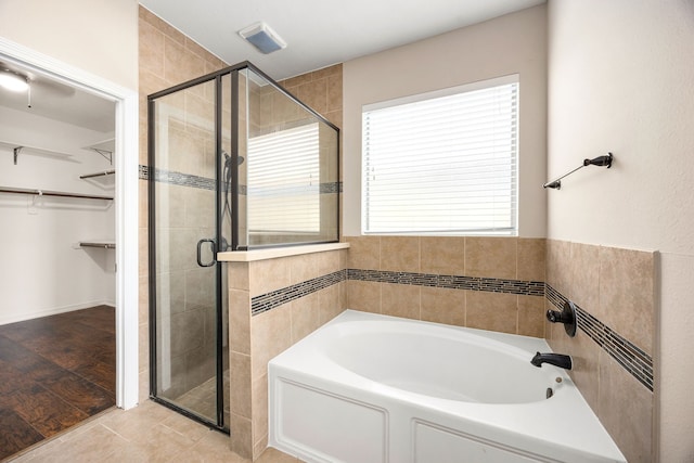 27106 Cottage Stream Ln, Fulshear, TX 77441 - full bathroom with a stall shower, a spacious closet, a bath, and tile patterned flooring