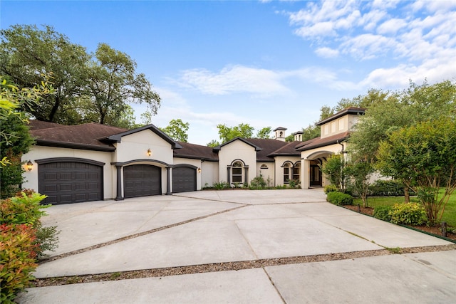 view of front of property featuring concrete driveway, stucco siding, and an attached garage