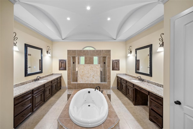 full bathroom with a tray ceiling, a tub with jets, a tile shower, two vanities, and recessed lighting