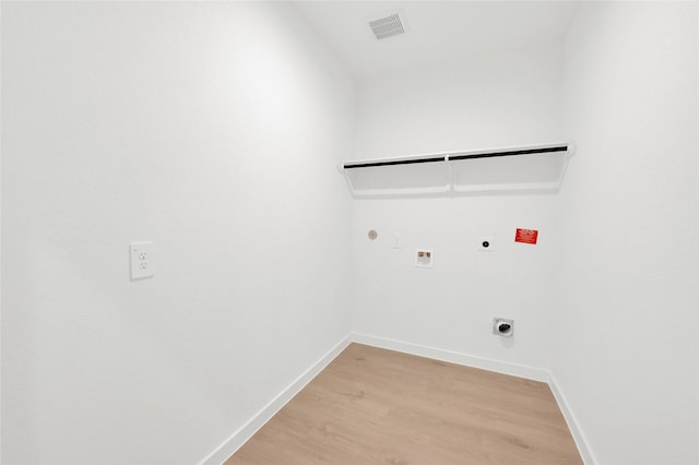 laundry room with hookup for an electric dryer, hookup for a gas dryer, washer hookup, light wood-style floors, and baseboards