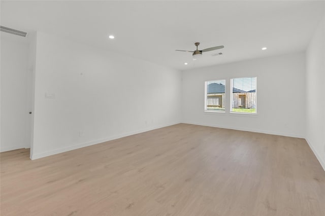 spare room featuring ceiling fan, recessed lighting, light wood-type flooring, and baseboards