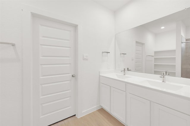 full bathroom with wood finished floors and double vanity