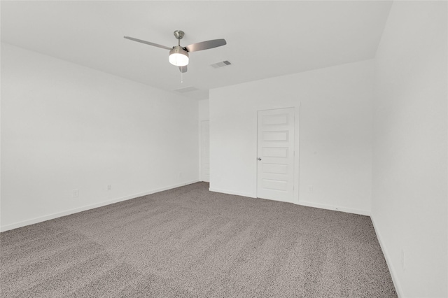 carpeted spare room featuring ceiling fan and baseboards