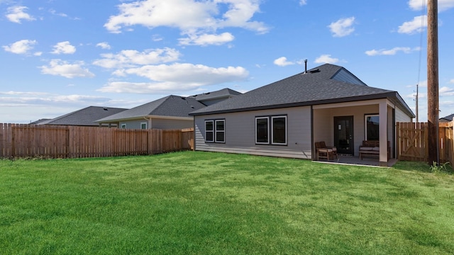 rear view of house with a shingled roof and a patio area