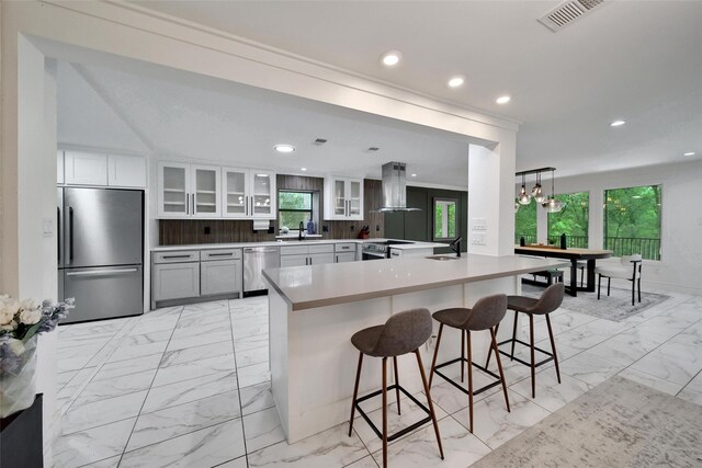 140 S Timber Top Dr, Spring, TX 77380 - kitchen with appliances with stainless steel finishes, a sink, light marble finish floors, range hood, and recessed lighting