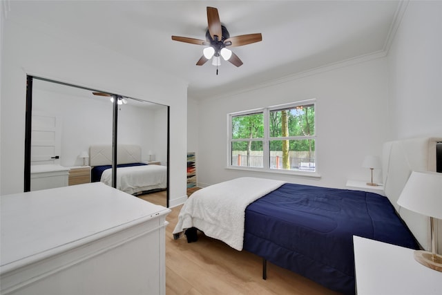 140 S Timber Top Dr, Spring, TX 77380 - bedroom with light wood-style floors, ornamental molding, a closet, and ceiling fan