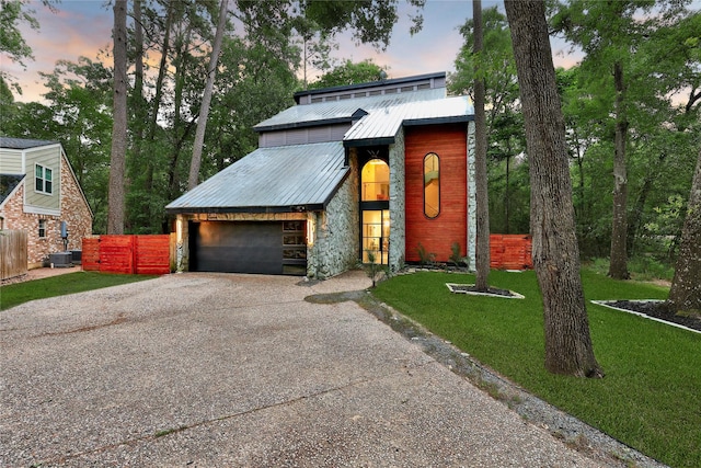 140 S Timber Top Dr, Spring, TX 77380 - view of front of house with driveway, a garage, stone siding, and metal roof
