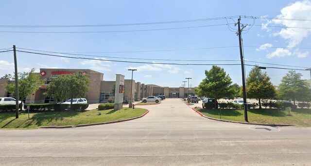 6051 Garth Rd Unit 3, Baytown, TX 77521 - view of concrete road with curbs and street lights