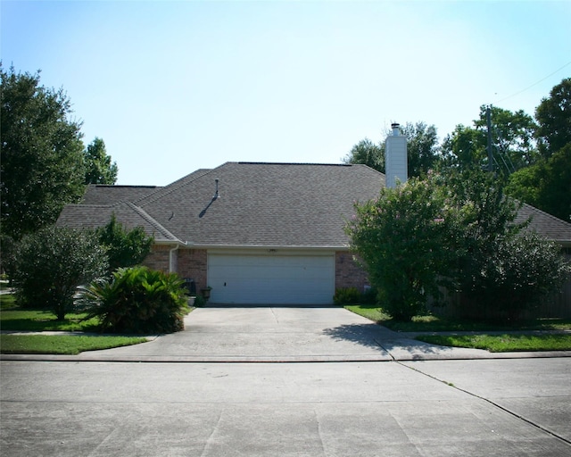 3002 Sandleigh Dr, Spring, TX 77388 - view of front of property with concrete driveway, brick siding, an attached garage, a chimney, and roof with shingles