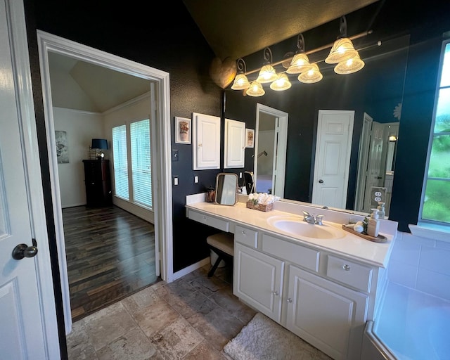 3002 Sandleigh Dr, Spring, TX 77388 - bathroom featuring lofted ceiling, vanity, and baseboards