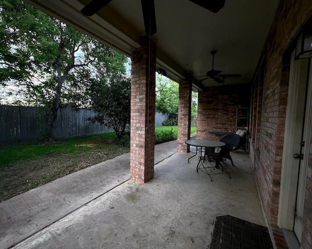 view of patio / terrace with a ceiling fan and fence
