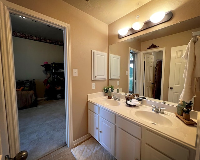 3002 Sandleigh Dr, Spring, TX 77388 - bathroom featuring double vanity and baseboards