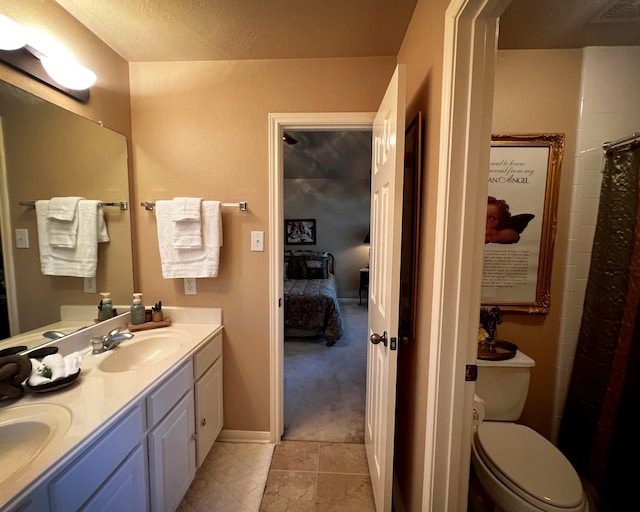 ensuite bathroom with toilet and double vanity