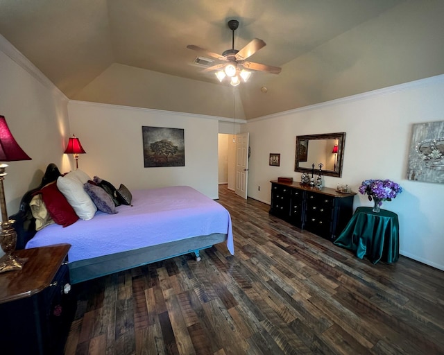 bedroom featuring wood finished floors, vaulted ceiling, a raised ceiling, ceiling fan, and ornamental molding