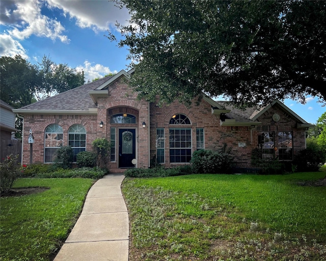 3002 Sandleigh Dr, Spring, TX 77388 - view of front of property with brick siding, a front yard, and a shingled roof