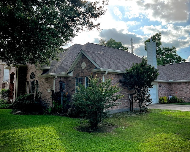 single story home with a garage, driveway, roof with shingles, and a front lawn