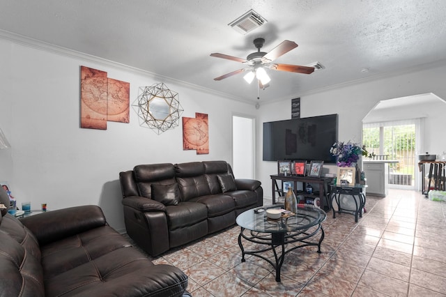 4914 Airport Blvd, Houston, TX 77048 - living room featuring ornamental molding, a ceiling fan, tile patterned floors, and arched walkways