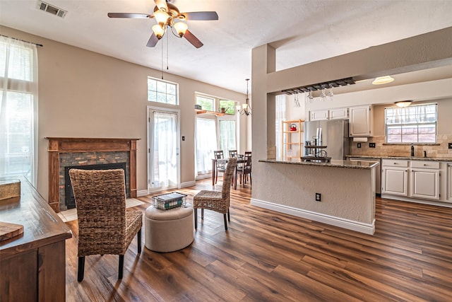 20423 Lone Star Oak St, Cypress, TX 77433 - living room featuring dark wood-style floors, a ceiling fan, a fireplace with flush hearth, and plenty of natural light