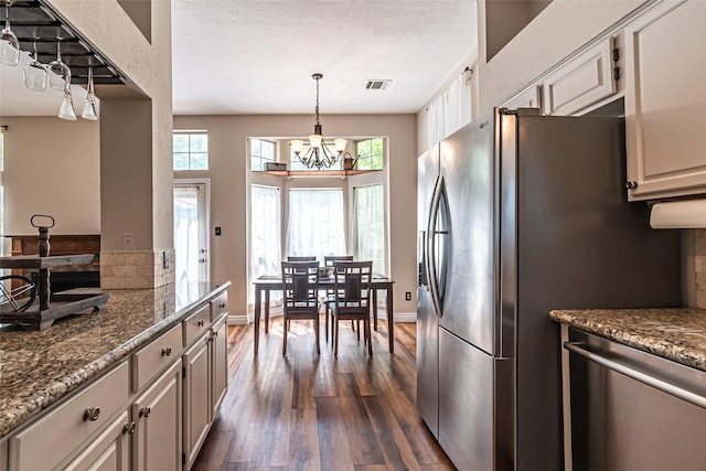 20423 Lone Star Oak St, Cypress, TX 77433 - kitchen featuring appliances with stainless steel finishes, dark wood-style flooring, a chandelier, healthy amount of natural light, and a textured ceiling